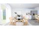 Bright dining area features a modern table, stainless steel refrigerator, and lots of light at 493 Lochalsh Dr, Gibsonville, NC 27249