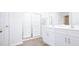 Bright main bathroom features a double vanity and glass enclosed shower at 493 Lochalsh Dr, Gibsonville, NC 27249