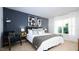 Cozy main bedroom with accent wall, soft lighting, and comfortable furnishings at 493 Lochalsh Dr, Gibsonville, NC 27249