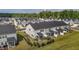 Aerial view of townhomes with manicured lawns and screened porches, offering a serene and well-maintained community at 5054 Kota St, Raleigh, NC 27610