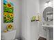Bright bathroom with sunflower decor, pedestal sink, and modern fixtures at 5054 Kota St, Raleigh, NC 27610
