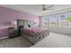 Spacious bedroom featuring a tray ceiling, large bed, and a view from the window at 5054 Kota St, Raleigh, NC 27610