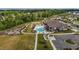 Extensive aerial view showcasing the community pool, playground, and amenities within a lush green landscape at 5054 Kota St, Raleigh, NC 27610