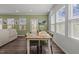 Cozy dining area features bright natural light, wood floors, and green accent wall at 5054 Kota St, Raleigh, NC 27610