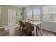 Bright dining area with wood table, green chairs, and sunny windows at 5054 Kota St, Raleigh, NC 27610