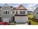 Charming two-story home featuring a light beige exterior, attached garage, and well-maintained landscaping at 5054 Kota St, Raleigh, NC 27610