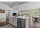 Open-concept kitchen boasts an island with dishwasher, connecting to living and dining areas at 5054 Kota St, Raleigh, NC 27610