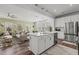 Open-concept kitchen with stainless appliances, island with barstool seating, and modern lighting at 5054 Kota St, Raleigh, NC 27610