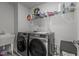 Fully equipped laundry room with modern washer, dryer, sink and shelving at 5054 Kota St, Raleigh, NC 27610