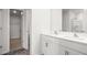 Bathroom with dual sinks, white cabinets, and a view into the walk-in closet at 506 Lochalsh Dr, Gibsonville, NC 27249