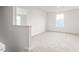 An airy bedroom offers neutral carpet and a bright window at 506 Lochalsh Dr, Gibsonville, NC 27249