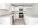 This modern kitchen features white cabinets and stainless-steel appliances at 506 Lochalsh Dr, Gibsonville, NC 27249