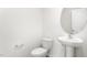 This powder room features a pedestal sink, oval mirror, and modern fixtures at 506 Lochalsh Dr, Gibsonville, NC 27249