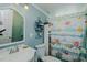 Charming bathroom with a sink, toilet, and patterned shower curtain at 5100 Yale Ct, Graham, NC 27253