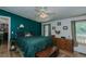 Cozy bedroom featuring a dark green accent wall and natural light at 5100 Yale Ct, Graham, NC 27253