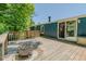 Spacious wooden deck with fire pit, offering an ideal space for outdoor entertaining at 5100 Yale Ct, Graham, NC 27253