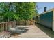 Outdoor deck with wooden railing and chimney extending from the roof at 5100 Yale Ct, Graham, NC 27253