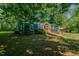 Quaint single-story home with lush greenery, carport, and inviting curb appeal at 5100 Yale Ct, Graham, NC 27253