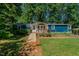 Charming blue single-story home with a wooden ramp leading to the front deck at 5100 Yale Ct, Graham, NC 27253