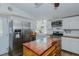 Bright kitchen with stainless appliances, island, and sink with window at 5100 Yale Ct, Graham, NC 27253