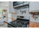 Close-up of white cabinets, stainless gas range, stainless microwave, wood countertops at 5100 Yale Ct, Graham, NC 27253
