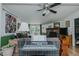 Cozy living room features a stone fireplace, wood floors, and view to the deck at 5100 Yale Ct, Graham, NC 27253