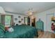 Spacious main bedroom featuring a ceiling fan, wood floors, and attached bathroom at 5100 Yale Ct, Graham, NC 27253