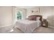 Cozy bedroom with comfortable queen-sized bed, neutral-toned walls, and a sun-filled window at 511 Lochalsh Dr, Gibsonville, NC 27249