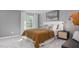 Modern bedroom featuring gray walls, a large window, and natural-tone accents at 511 Lochalsh Dr, Gibsonville, NC 27249