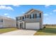 Attractive gray two-story home featuring a two-car garage and neat landscaping at 511 Lochalsh Dr, Gibsonville, NC 27249