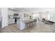 Open concept kitchen with a center island, grey cabinets, and stainless steel appliances at 511 Lochalsh Dr, Gibsonville, NC 27249