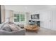 Comfortable living room features a plush sofa, round coffee table, and a large window for ample natural light at 511 Lochalsh Dr, Gibsonville, NC 27249