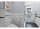 Bright bathroom featuring white subway tile, glass enclosed shower, and blue and black mosaic tile floor at 518 S Main St, Wake Forest, NC 27587