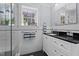Bright bathroom featuring white subway tile, black countertops, vanity, and mosaic tile floor at 518 S Main St, Wake Forest, NC 27587