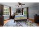 Comfortable bedroom featuring a bed with a patterned rug and plenty of natural light from the windows at 518 S Main St, Wake Forest, NC 27587
