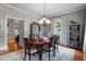 Elegant dining room featuring hardwood floors, a stylish chandelier, and plenty of natural light at 518 S Main St, Wake Forest, NC 27587