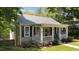 Well-maintained home with gray siding, black shutters, and a welcoming front porch at 518 S Main St, Wake Forest, NC 27587
