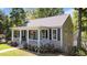 Charming home with covered porch, landscaping, and delightful curb appeal at 518 S Main St, Wake Forest, NC 27587