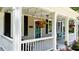 Charming front porch with hanging flower basket, seating, and string lights at 518 S Main St, Wake Forest, NC 27587