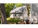 Exterior view of detached garage with door and two windows and tree shade with landscaping at 518 S Main St, Wake Forest, NC 27587
