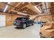 View inside the spacious two car garage with wood beams and storage at 518 S Main St, Wake Forest, NC 27587