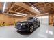 View inside the spacious two car garage with wood beams and storage at 518 S Main St, Wake Forest, NC 27587