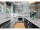 Well-appointed kitchen with custom cabinets, stainless steel appliances, and a farmhouse sink at 518 S Main St, Wake Forest, NC 27587