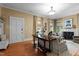 Cozy living room featuring a fireplace, hardwood floors, and large windows for natural light at 518 S Main St, Wake Forest, NC 27587