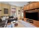 Cozy living room showcases built-in wooden cabinets, a large television, and comfortable seating area at 518 S Main St, Wake Forest, NC 27587