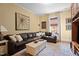 Inviting living room with a large leather sectional sofa and a bright white coffee table on a patterned rug at 518 S Main St, Wake Forest, NC 27587