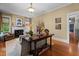 Bright living room featuring hardwood floors, a fireplace, and large windows for plenty of natural light at 518 S Main St, Wake Forest, NC 27587
