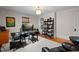 Bright office featuring hardwood floors, neutral walls, and a large bookcase at 518 S Main St, Wake Forest, NC 27587