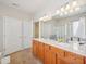 Well-lit bathroom with double vanity, tile flooring, and a glass-enclosed shower, offering modern amenities at 519 Garendon Dr, Cary, NC 27519