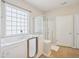 Bright bathroom features a walk-in tub with glass block window and a separate glass-door shower at 519 Garendon Dr, Cary, NC 27519